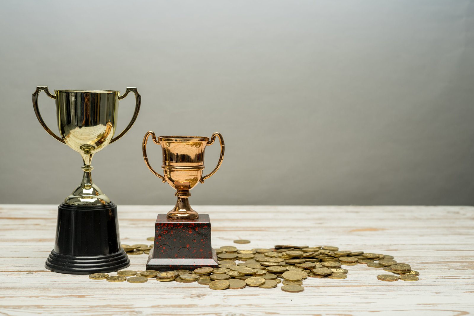 Golden Trophy on bed of coins.Successful financial plan concept.