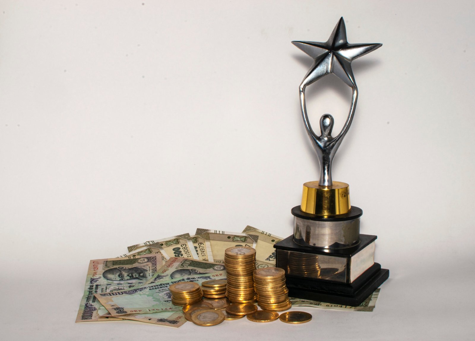 Indian currency notes and coins with a trophy, finance, trading and loan image